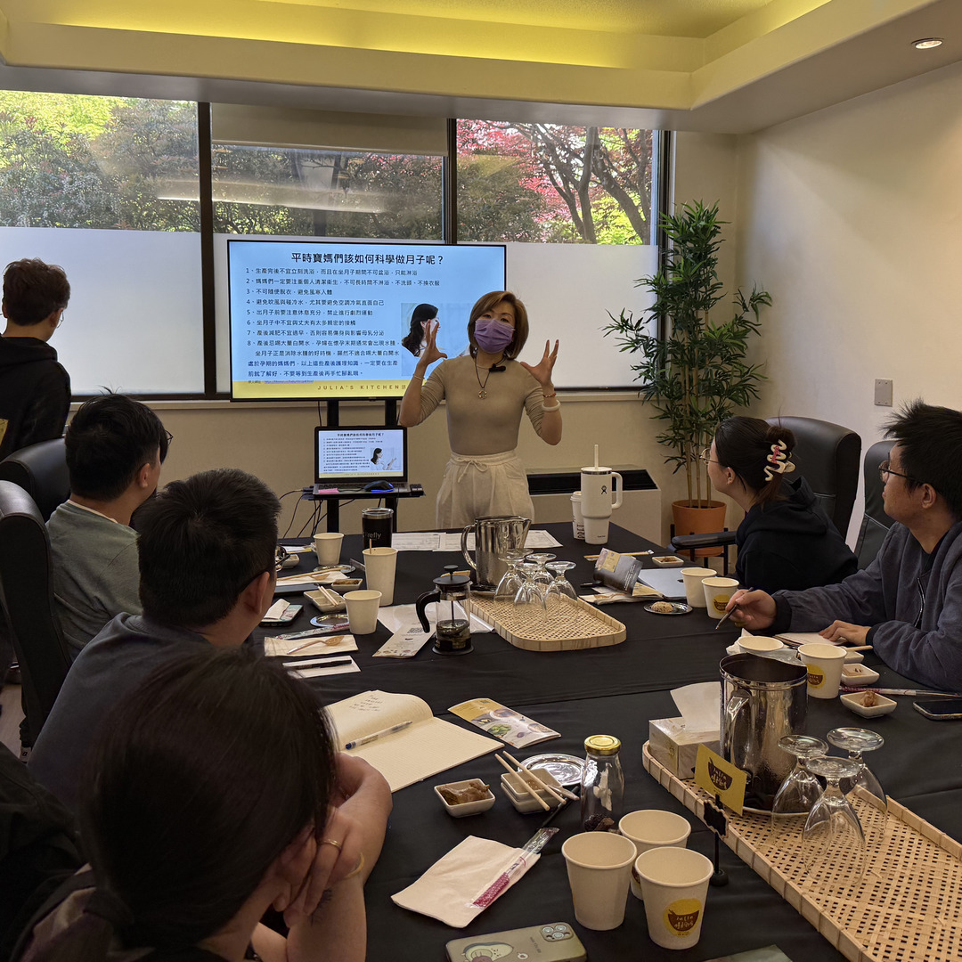 Julia presenting traditional postpartum meal wisdom to attentive workshop attendees